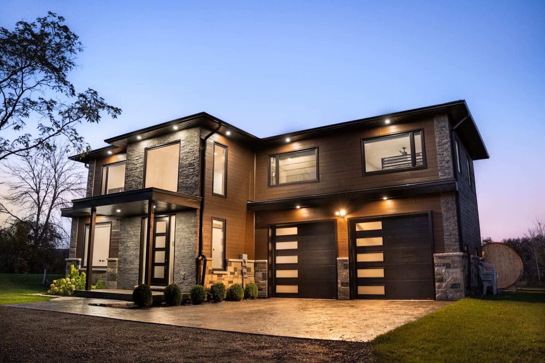Modern two-storey home at dusk, managed by TNG