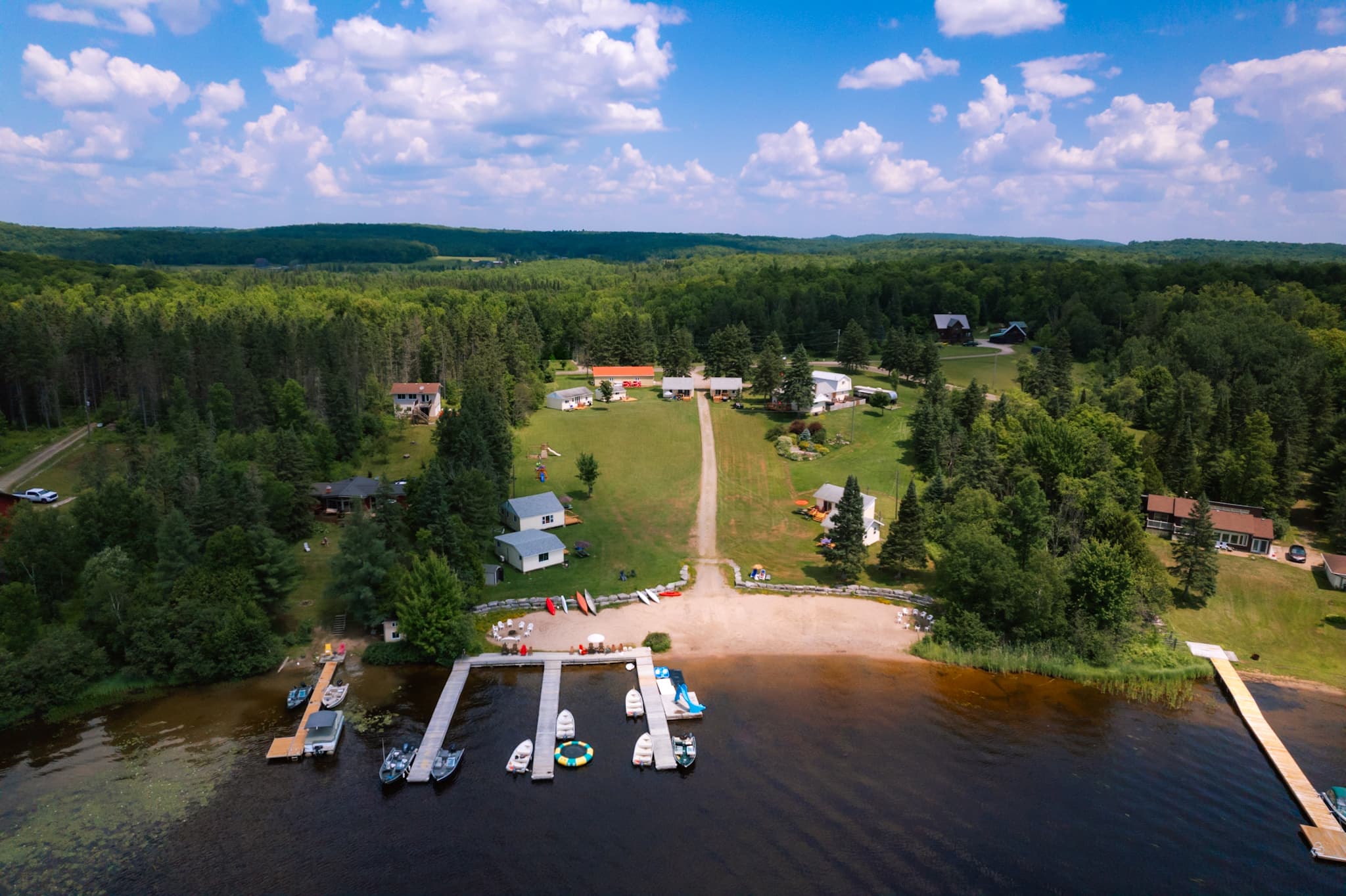 Aerial view of Lake Cecebe’s Resort & Marina, its cottages, beach, and docks