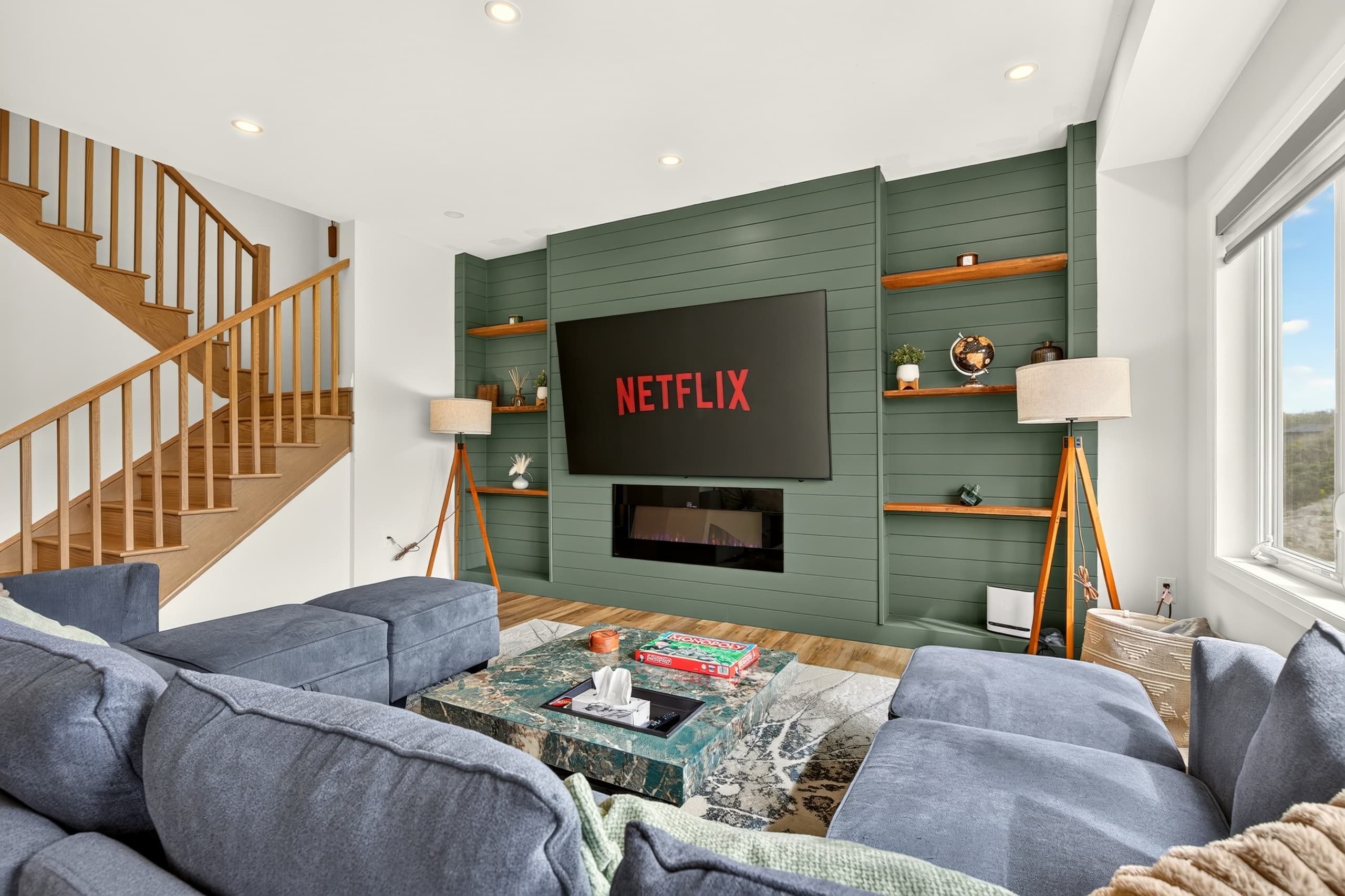Owen’s House living room with green built-ins and Netflix on the TV